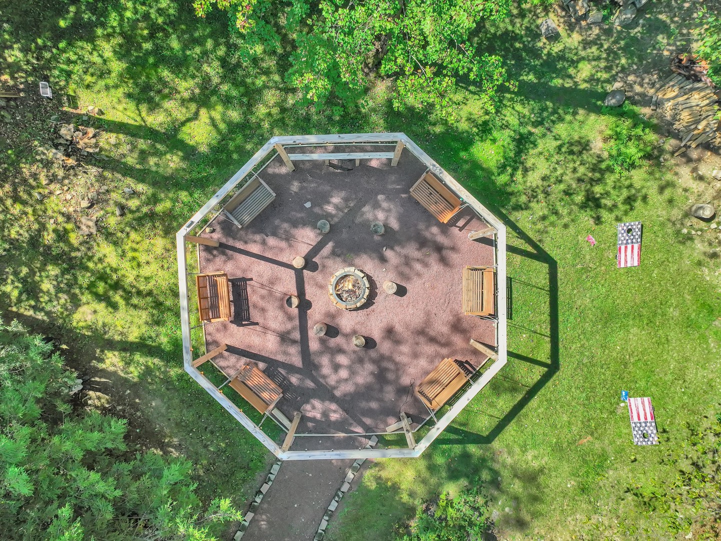 Aerial view of your private backyard oasis, complete with a custom gazebo fire pit and games on the lawn.