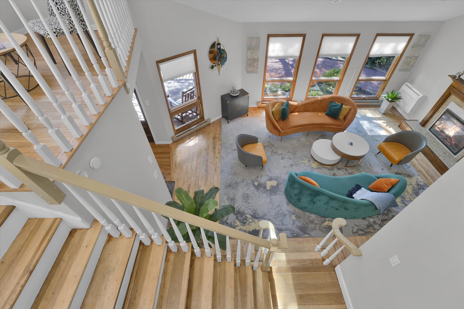 Soaring ceilings, custom staircase, and sunlit lounge space on the main level.