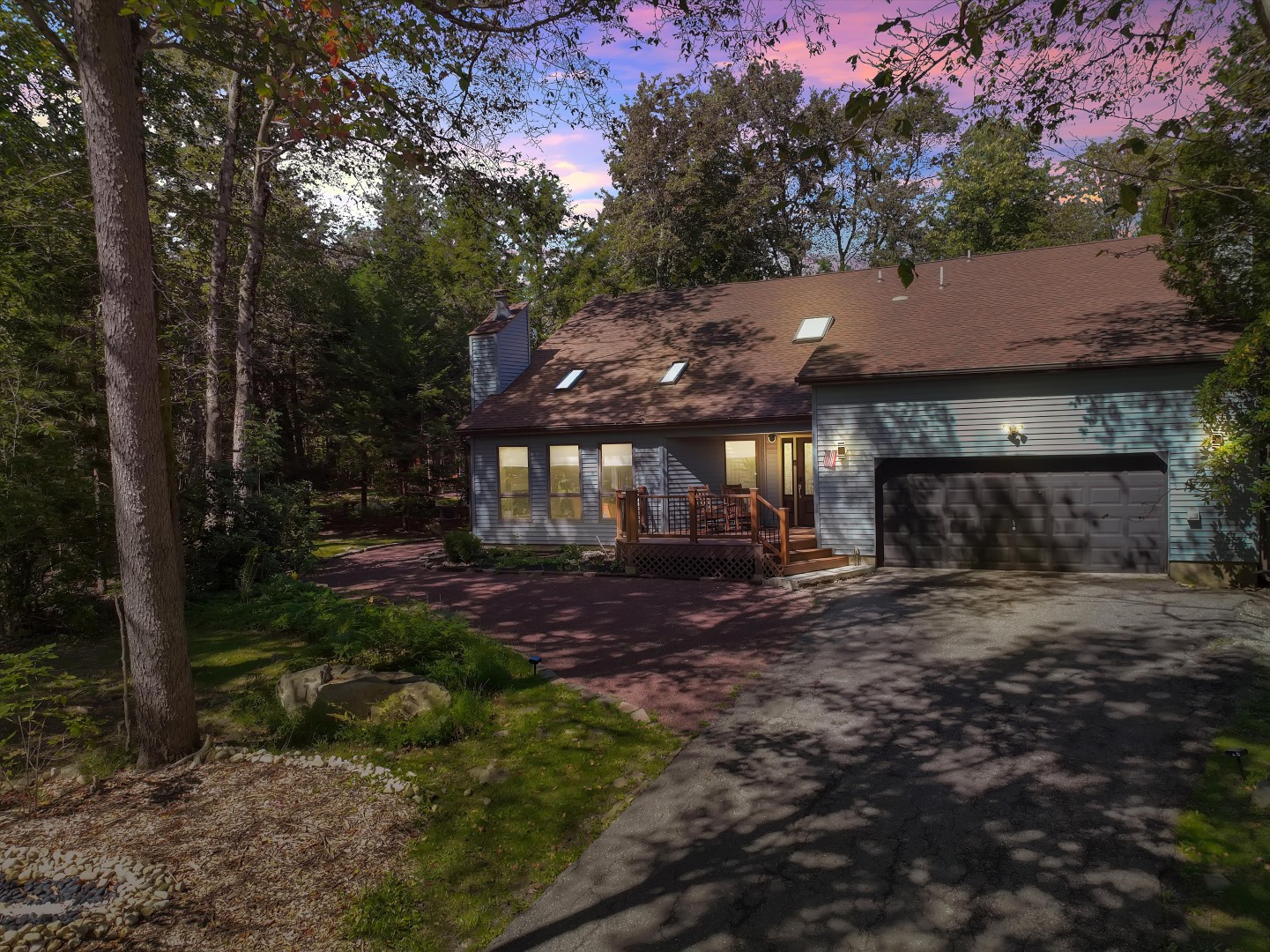Tucked away in quiet nature, this charming mountain retreat offers ample driveway parking and a cozy forest backdrop.