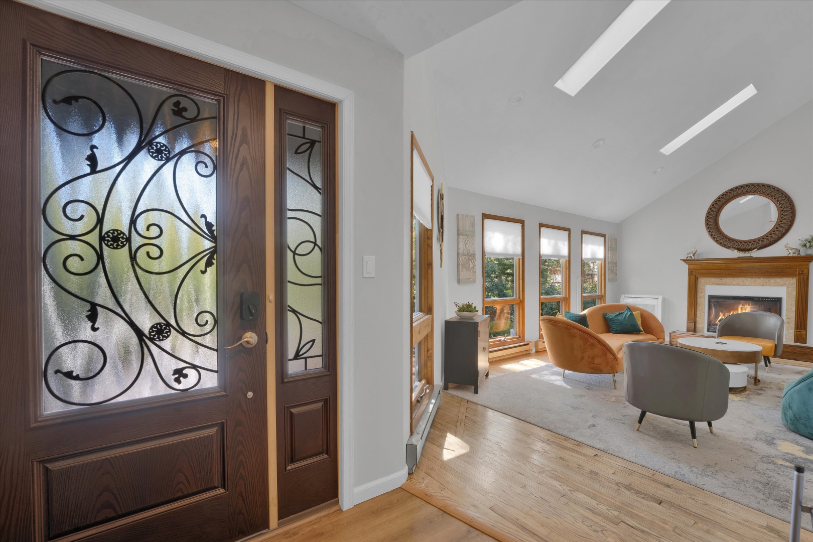 An inviting front entry featuring ornate glass doors that open right into the sunlit main living space.